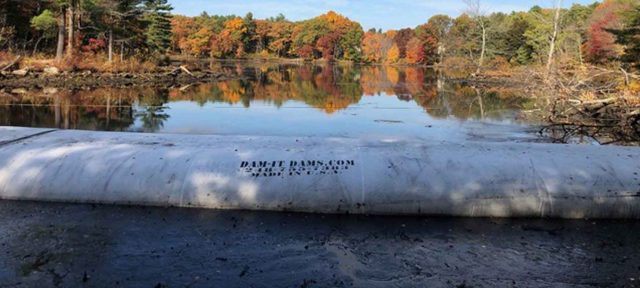 cofferdam with colorful fall trees in the background